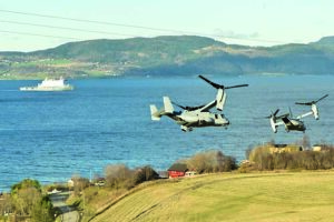 U.S. Marine Corps MV-22 Ospreys take off following a simulated casualty evacuation at a media event held during Exercise Trident Juncture 18. The Royal Netherlands Navy ship HNLMS Johan de Witt can be seen in the background.